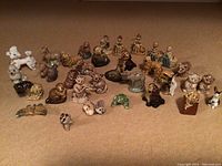 Wide view showing entire figurine set arranged on carpeted floor, showing dog, human, and animal miniatures