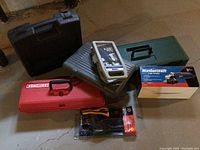 Photo of assorted toolboxes and hand tool set displayed on the floor.