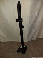 Electric Jobmate grass trimmer shaft with protective guard near cutting head.