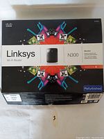 Front of the refurbished Linksys N300 Wi-Fi Router box showing product branding and colorful design.