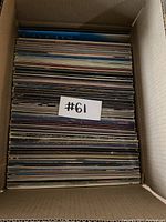 Top view of the box packed with vinyl records labeled #61, showing many records stacked upright.