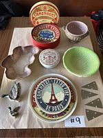 Photo of the full assortment of Camembert cheese boards, various ceramic bowls and dishes, and small ceramic bird-shaped cheese markers.