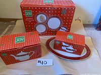 Photo of boxed Holiday Joy 20-piece dinnerware set and several boxes showing dishes and packaging.