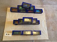 Overview of eleven boxed die-cast Tintin vehicles arranged in three rows