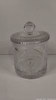 Front view of assembled crystal biscuit jar with lid showing detailed floral and pinwheel cut patterns.