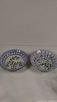 Two Porches Pottery bowls side by side showing floral patterns and decorative rims