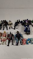 Closer view of Batman and surrounding action figures showing condition and variety.