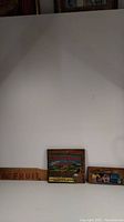 Full view of three wooden crate end boards displayed against wall