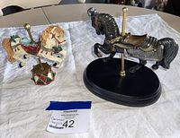 Two carousel horse figurines displayed together, showing size and condition of lot