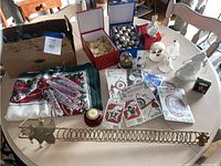 Photo showing the various Christmas decorations including fabric, ornaments, craft items, and decorative figures on a table