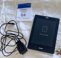 Photo of Kobo tablet reader powered off with charger and auction label visible.