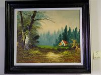 Framed oil on canvas painting showing a green landscape with trees and a small house with a red roof in the distance, signed by the artist.