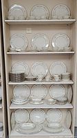 Full display of multiple shelves showing plates and cups