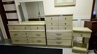 Full view of the dresser, chest, mirror, and nightstand set with light wood finish and metal handles