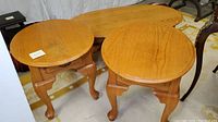 Full set of oak wood tables, two round end tables and one elongated oval coffee table