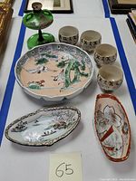 Overview of the set showing the green lamp, four tea cups, one large bowl, and two oval bowls.