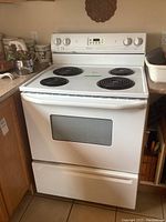 Front view of white Maytag Preforma electric stove in kitchen setting