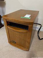 Sunheat electric infrared portable heater front and side view showing wooden exterior and vent with power switch.