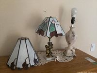 Photo showing the two lamps with resin stained glass style shades: one on a stone resin base (about 20" tall), the other on a metal base (about 15" tall).
