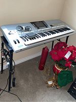 Full view of Yamaha keyboard on adjustable stand with pedal and cable