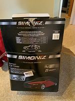 Photo of the Simoniz Platinum Series packaging showing car cover specifications and size chart.