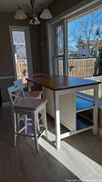 View of entire kitchen island and both chairs from side