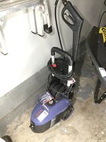 Full view of Simoniz pressure washer unit with hose wrapped around frame