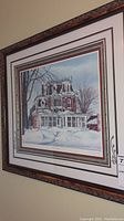 Framed signed print titled 'Antique Glass' showing Victorian house in winter with snow. Signed by Lindsey Ross, detailed carved wooden frame.