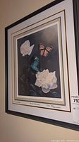 Framed floral print featuring white roses and butterflies, signed and numbered by Debi Fitzgerald, titled "Love's Promise"