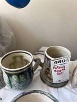 Two pottery steins side by side, showing glaze and general shape