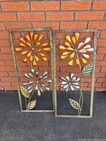 Full view of two matching 3D metal wall art panels with floral motifs showing size and design