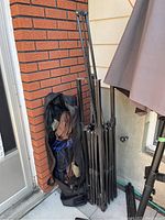 Canopy frame standing next to a brick wall with the carry bag beside it.