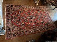 Full view of rug laid on hardwood floor showing overall pattern and size