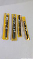 Four new Hawera drill bits for concrete, sizes 1/2", 5/8", 3/8", and 5/16" in yellow packaging on white surface.