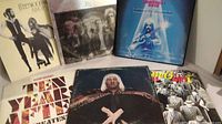 Six classic rock vinyl albums arranged showing front covers, including Fleetwood Mac, Edgar Winter, and others.
