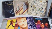 Photo of six classic rock vinyl album covers arranged in two rows showing variety of cover art styles and artists.