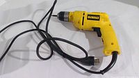 Side view of the yellow DeWalt DW106 3/8 inch corded drill with power cord visible, showing condition and design.