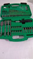 Full view of drill bit set in green case showing all drill bits, spade bits, screwdriver bits, and accessories