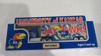 Front view of the University of Kansas Jayhawks diecast truck in original box, showing colorful Jayhawks graphics and branding on truck and packaging.