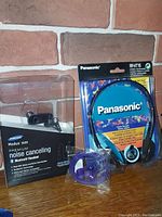 Panasonic RPHT116 headphones in packaging showing front with colorful cardboard insert and plastic cover.