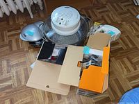 Overview of lot showing Aroma hot air cooker with glass bowl and metal handles, sandwich toaster, boxes, and other appliances.