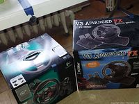 Photo showing boxes of Logitech Driving Force GT and V3 Advanced FX Racing Wheel side by side