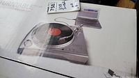 Boxed ION USB turntable showing product image and USB hookup details on packaging.