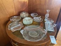 Wide view of all glassware items and metal plate on wooden table