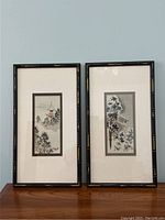 Two framed and matted Japanese signed watercolour paintings, vertical orientation with dark bamboo-style frames.