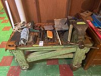 Workbench with bench vise and assorted tools on top