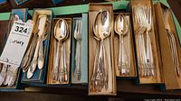 Complete boxed set of Rogers Bros silver plated cutlery including forks, spoons, and butter spreaders.