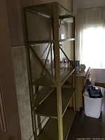 Full view of metal shelving unit aligned against wall showing height and profile.