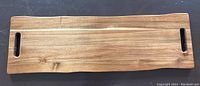 Top view of a 3ft long rectangular wooden charcuterie board with handles on each end, showing wood grain and smooth finish.