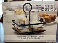 Box packaging showing the Gourmet Basics revolving condiment caddy with compartments for condiments and utensils, including a rotating handle and wooden base.